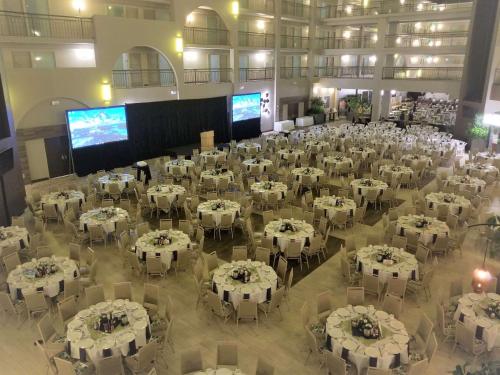 a large banquet hall with white tables and chairs at Embassy Suites by Hilton Seattle North Lynnwood in Lynnwood