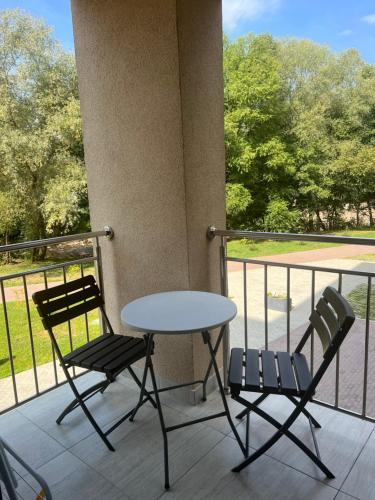 two chairs and a table on a balcony at ЖК «Сонячний квартал» in Solochin
