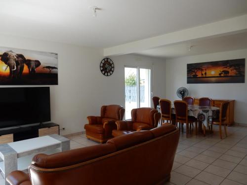 a living room with a couch and a table at Maison 3 chambres 120m2 3km ploermel in Ploërmel