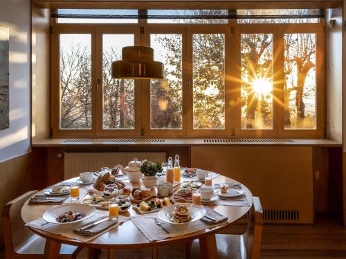 una mesa con comida delante de una ventana en Casa das Penhas Douradas - Burel Expedition Hotel, en Manteigas