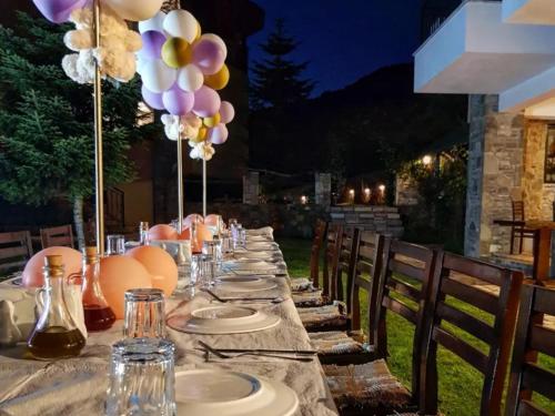 a long table with plates and balloons on it at Sofra E Shpatit in Elbasan