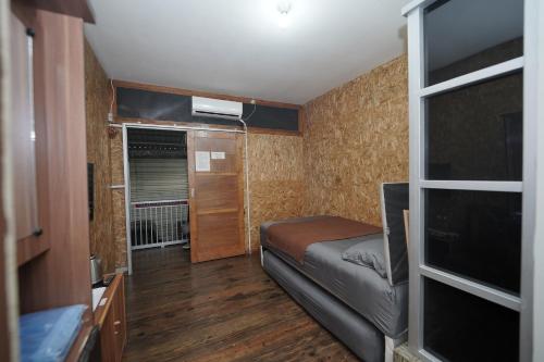 a small room with a bed and a flat screen tv at Hotel Soreang in Bandung