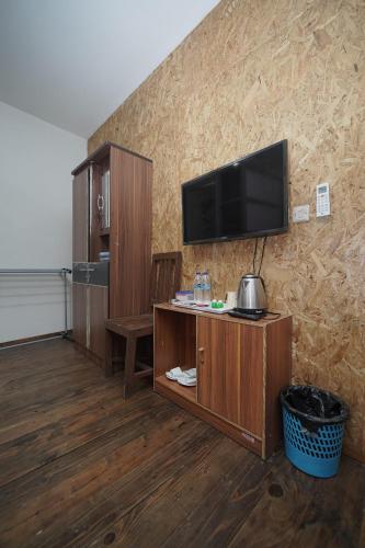 a living room with a flat screen tv on a wall at Hotel Soreang in Bandung