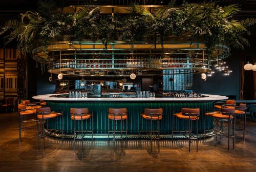 a bar in a restaurant with stools at EPISODE Hsinchu, JdV by Hyatt Hotel in Hsinchu City