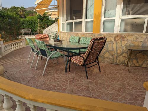 a patio with a table and chairs on a balcony at Villa Carmen in Torrox Costa