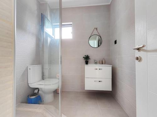 a bathroom with a toilet and a glass shower at Vila MOON in Bezdead