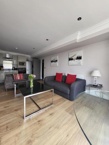 a living room with a couch and a table at Harrogate Lifestyle Luxury Serviced ApartHotel in Harrogate