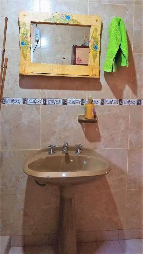 a bathroom with a sink and a mirror at Cabaña Carmela in Garupá