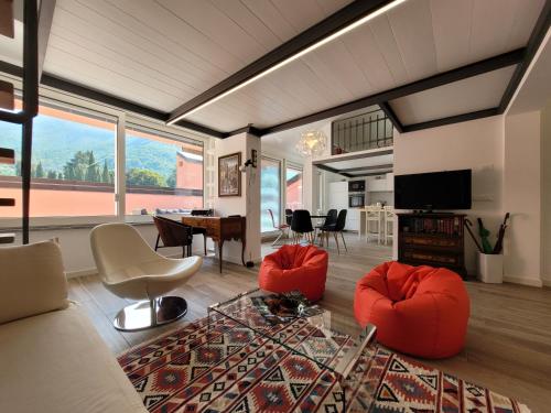 a living room with a couch and chairs and a table at Aros Mountain Lake Iseo Hospitaliy in Pisogne