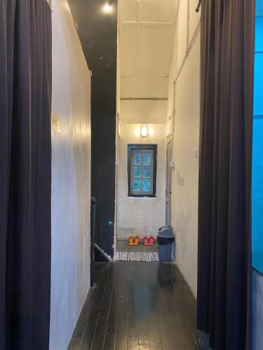 an empty hallway with a window in a building at Hikers Sleep Port Guesthouse in Cameron Highlands