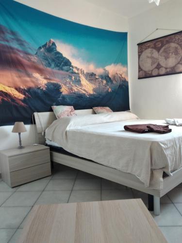 a bedroom with a mountain mural on the wall at CasarinoLaurino Among Cinque Terre Genova And Portofino in Uscio