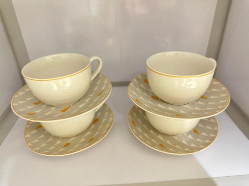 two tea cups and saucers on a shelf at Mehad Stay for Self Check-In Apartment in Jeddah