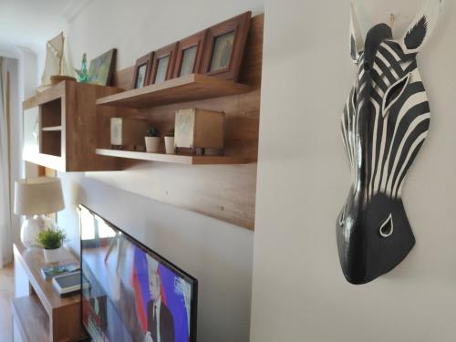 a living room with a zebra head on the wall at Acogedor apartamento en Boiro in Boiro