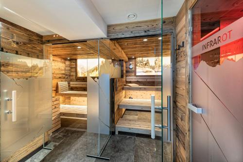 a sauna in a room with a glass door at Alpengasthof Praxmar in Sankt Sigmund im Sellrain
