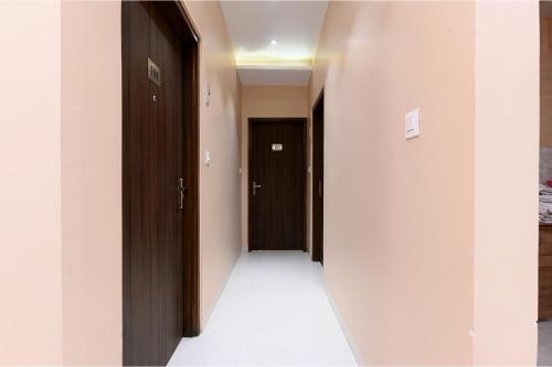an empty hallway with two doors and a hallwayngth at FabHotel 7th Crossing Malviya Nagar in Jaipur