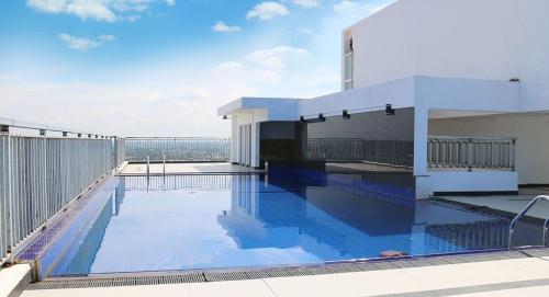a swimming pool on the roof of a building at Blue Ocean in Dehiwala