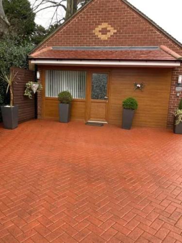 a brick driveway in front of a house at Private Annex with Two Bedrooms in Upton