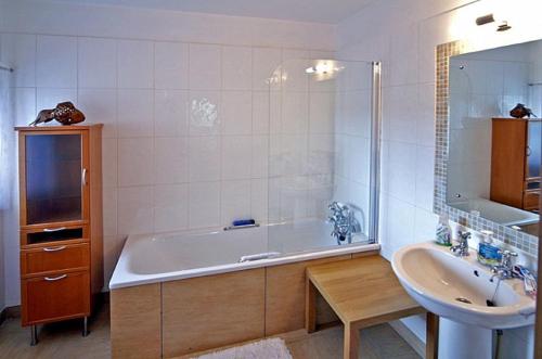 a bathroom with a bath tub and a sink at Doonreagan East Wing, Cashel in Canower
