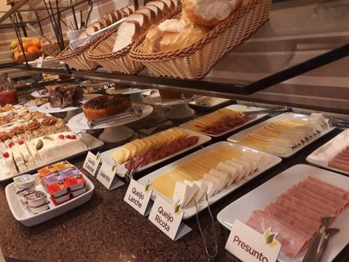 una vitrina en una panadería con muchos tipos diferentes de pan en Hotel Premium en Gramado