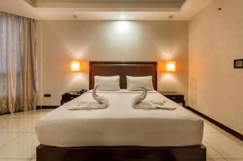 two swans carved into a bed in a hotel room at The Bentley Seaside Boutique Hotel in Chennai