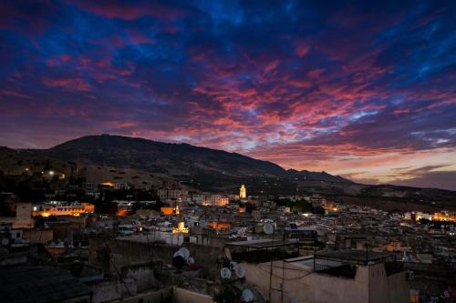 a view of a city at sunset at Riad Diamant De Fes in Fès