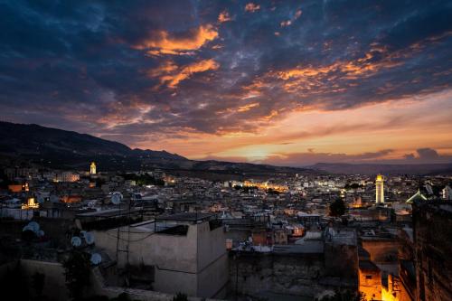 a view of a city at sunset at Riad Diamant De Fes in Fès