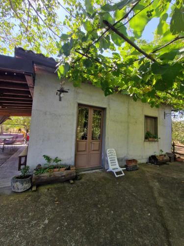 a white chair sitting in front of a house at La casa di Giulia in Bronte