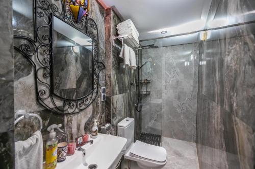 a bathroom with a sink and a toilet and a mirror at Riad Diamant De Fes in Fès