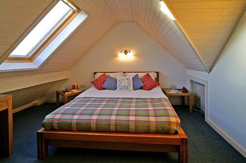 a bedroom with a bed in a attic at Doonreagan East Wing, Cashel in Canower