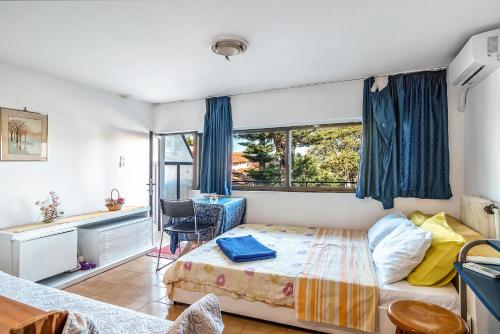 a bedroom with a bed and a desk and a window at Studio in Gastouni in Gastoúni