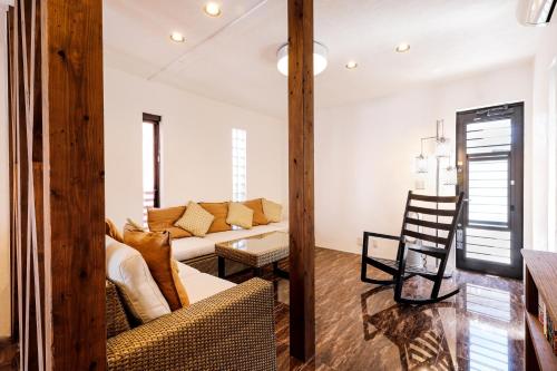 a living room with a couch and a table at Bello House Imabari in Imabari