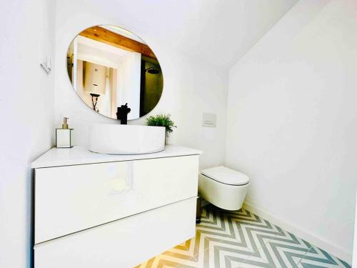 a bathroom with a white sink and a mirror at New Amaizing Cozy House in the heart Lisbon in Lisbon