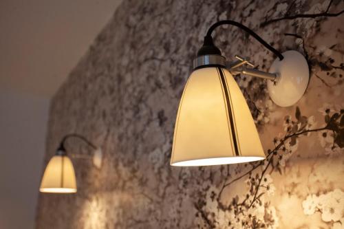 two lights are hanging on a wall at The King's Arms in Dorchester