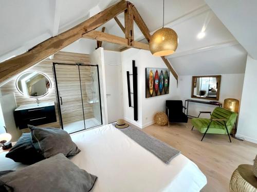 une chambre avec un grand lit blanc et un bureau dans l'établissement Évasion Prestige sur l'Île Koeur, à Lézardrieux