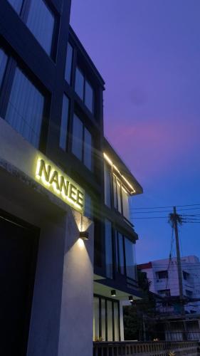a building with a nane sign on the side of it at NANEE Phra Singh in Chiang Mai