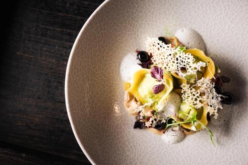 a white plate with food on a table at Hotel Wagnerhof in Pertisau