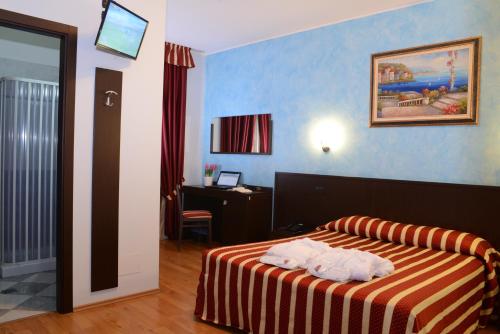 a hotel room with a bed with towels on it at Hotel Iacone in Chieti