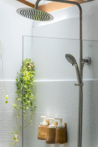 a bathroom with a shower with a shower head at Oasis Yoga Bungalows in Ko Lanta