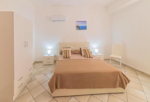 1 dormitorio con 1 cama grande y 2 mesitas de noche en Appartamento Rock of lovers en Isquia