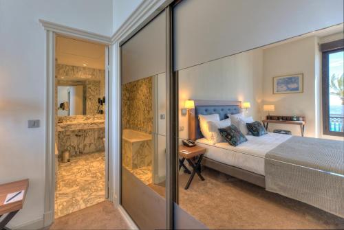 a bedroom with a king sized bed and a shower at Westminster Hotel & Spa Nice in Nice