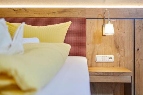 a bedroom with a bed and a light on a wall at Appartement Loser mit Indoorpool und Sauna in Bad Goisern