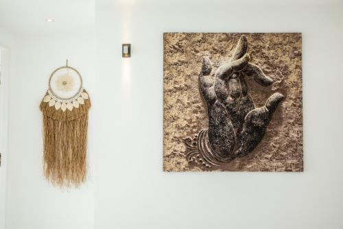 a museum exhibit with a broom and a picture of a hand at 5House:A luxury beachfront villa on Samui 滨海5卧室别墅 in Hua Thanon Beach