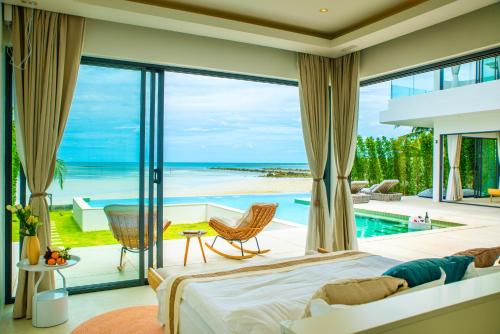 a bedroom with a view of the ocean at 5House:A luxury beachfront villa on Samui 滨海5卧室别墅 in Hua Thanon Beach