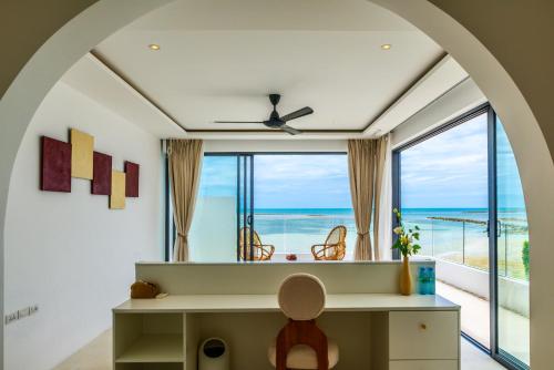an arched room with a desk and a large window at 5House:A luxury beachfront villa on Samui 滨海5卧室别墅 in Hua Thanon Beach