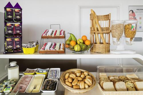 a shelf filled with food and other food items at ibis Budget Luxembourg Sud in Livange