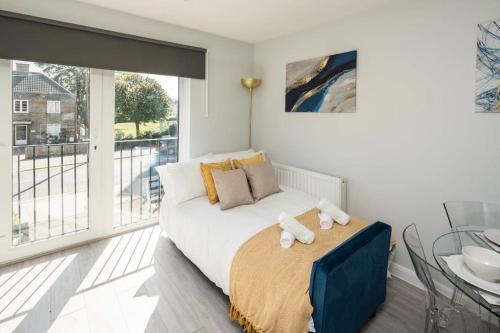 a bedroom with a bed and a balcony at Smart Living Sophisticated Style - Photo ID Required in London