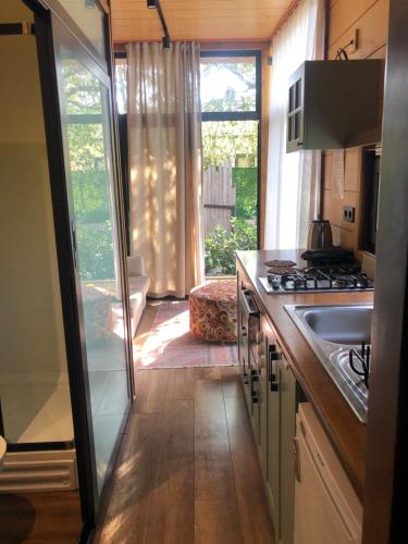 a kitchen with a sink and a stove at Tiny house kayaköy kumquat in Kayakoy