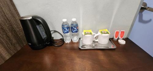 a telephone and two water bottles on a table at Grapevine Garden in Kota Kinabalu