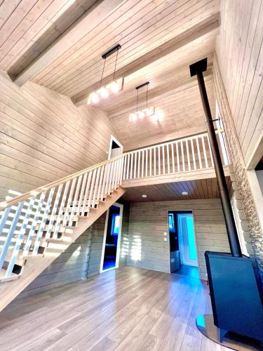 an empty room with a staircase in a house at Vila Scandinavia in Sîngeorgiu de Mureş