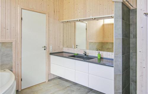 a bathroom with a sink and a mirror at Amazing Home In Fjerritslev With Wifi in Torup Strand